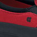 A close up of a red and black Shoes For Crews Ollie II men's canvas shoe with a black sole.