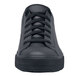 A close up of a black Shoes For Crews Delray women's shoe with laces on a table.