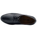 A close-up of a black Shoes For Crews Madison III dress shoe for women with laces.