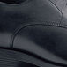 A close up of a black Shoes For Crews Senator dress shoe.