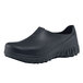 A black Shoes For Crews men's work shoe with rubber soles.