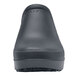 A black Shoes For Crews women's casual shoe with a white background.
