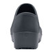 A close-up of a black Shoes For Crews women's shoe with a black sole.