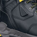 A close up of a black and yellow Redrock work boot with a composite toe.