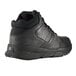 A black Shoes For Crews men's water-resistant athletic shoe with a rubber sole.