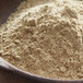 A bowl of Regal ground white pepper powder in a wooden bowl.