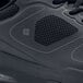 A close up of a black Shoes For Crews Evolution II men's athletic shoe on a table.