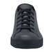 A close up of a black Shoes For Crews Delray leather shoe with laces.