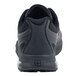 The bottom of a black Shoes For Crews Evolution II athletic shoe with a soft toe.