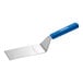 A Dexter-Russell Sani-Safe hamburger turner with a blue handle.