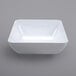 A white square bowl on a gray background.