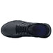 A black Shoes For Crews Stride athletic shoe with blue accents.