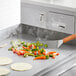 a pizza and vegetables cooking on a stove