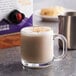 A glass mug of Oregon Chai Original Chai Tea Latte on a white background.