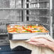 a person holding a tray of food