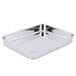 A Vollrath stainless steel roasting pan with handles on a counter.