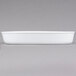 a white rectangular dish with a spoon