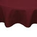 A burgundy Intedge round tablecloth on a table.