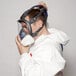 A man in a white suit holding a 3M full face respirator.