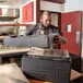 A man opening a Cambro Cam GoBox food pan carrier box.