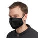 A man wearing a black Mercer Culinary face mask.