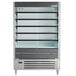 A Beverage-Air VueMax air curtain merchandiser with shelves in a large display case.