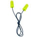 A pair of yellow 3M E-A-Rsoft earplugs with a cord.