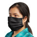 A woman wearing a black Mercer Culinary face mask.