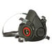 A black 3M 6300 respirator with a red circle on it.