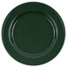 A Crow Canyon Home forest green enamelware plate with speckled surface and black rim.