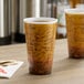 Two Dart Fusion Escape foam cups with writing on them on a table.