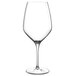 A close-up of a Luigi Bormioli Atelier Chianti wine glass with a stem on a white background.