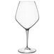 A close-up of a Luigi Bormioli Atelier Shiraz wine glass with a clear stem.