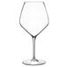 A close-up of a Luigi Bormioli Atelier Pinot Noir wine glass with a thin stem.