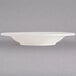 An ivory china bowl with an embossed rim.