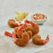 Fried shrimp coated in Golden Dipt bread crumbs with a bowl of sauce.