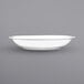 An International Tableware bright white porcelain serving bowl with a rolled edge.