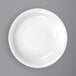 A close-up of an International Tableware Bristol bright white soup bowl with a rolled edge.