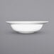 A close up of an International Tableware Bristol white porcelain pasta bowl with a wide rim.