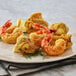 A plate of fried shrimp with lemon slices on it.