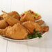 A plate of Golden Dipt Crispy Seasoned Fried Chicken with salad.