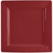 An International Tableware square porcelain plate with a red surface and white border.