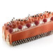 A chocolate cake with raspberries and cream baked in a Silikomart 4 compartment log mold.