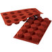 A red Silikomart silicone baking mold with 15 octagon cavities.