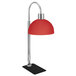 a red lamp with a metal pole