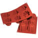 A close-up of a red Silikomart Pandorino silicone baking mold with 6 compartments.