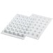 A white Silikomart silicone baking mold tray with 35 truffle-shaped cavities.