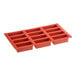 A red rectangular Silikomart silicone baking mold with 12 compartments.