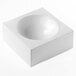 A white square silicone baking mold with a round center.