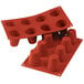 A red silicone baking mold with eight big baba cavities.